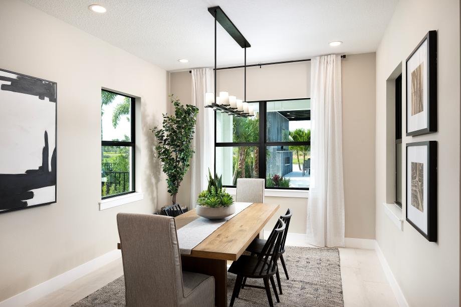Casual dining area in the Selby model at Monterey with large windows overlooking the lanai